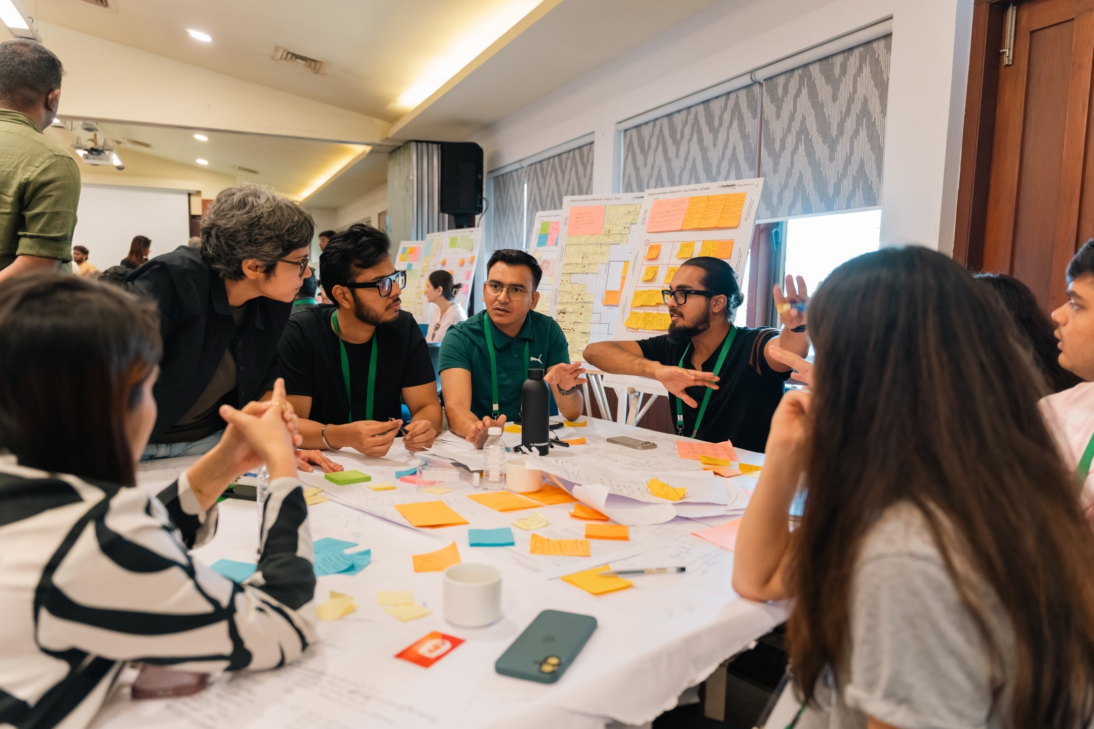 Learners and mentors collaborating around a workshop table